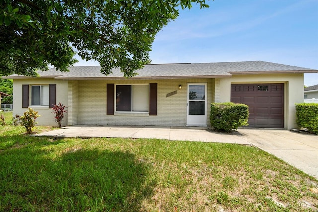 ranch-style home featuring a garage and a front yard