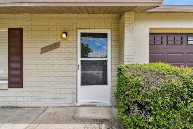 view of exterior entry with a garage