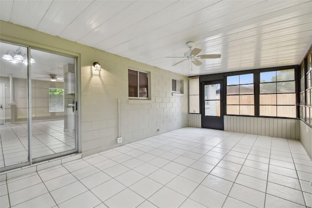 unfurnished sunroom with ceiling fan