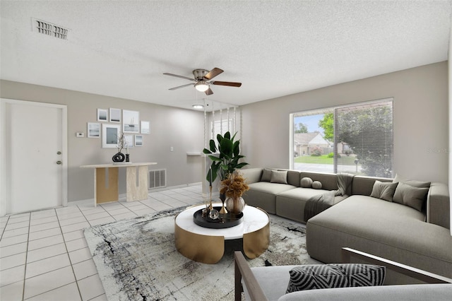 tiled living room with a textured ceiling and ceiling fan