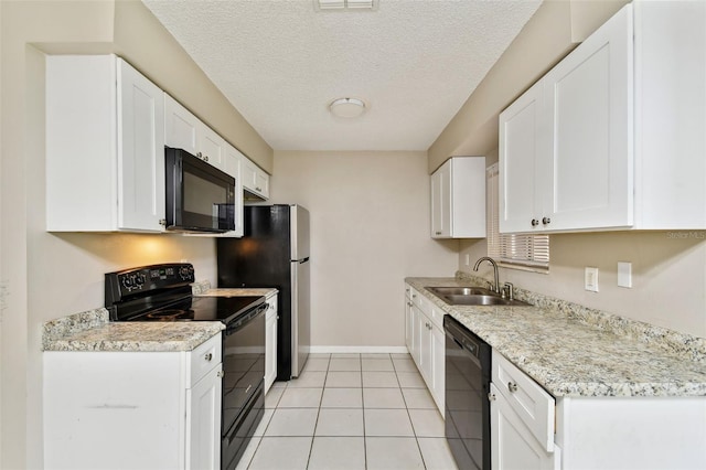 kitchen with white cabinetry, black appliances, sink, and light tile patterned floors