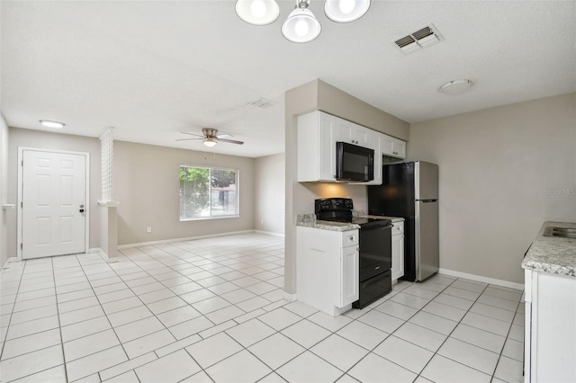 kitchen featuring light tile patterned flooring, ceiling fan, white cabinetry, and black appliances