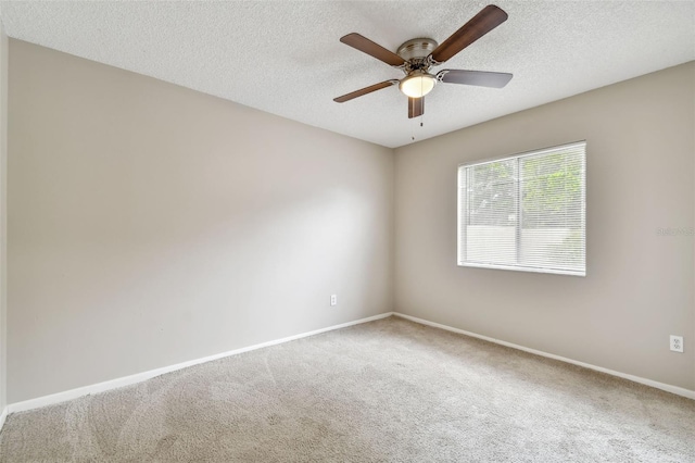 spare room featuring ceiling fan, a textured ceiling, and carpet floors