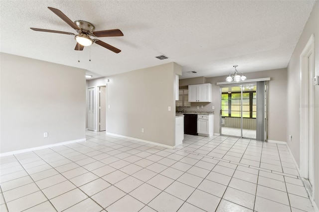 unfurnished living room featuring a textured ceiling, light tile patterned floors, and ceiling fan with notable chandelier