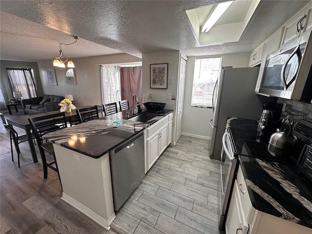 kitchen featuring white cabinetry, light hardwood / wood-style flooring, stainless steel appliances, and sink