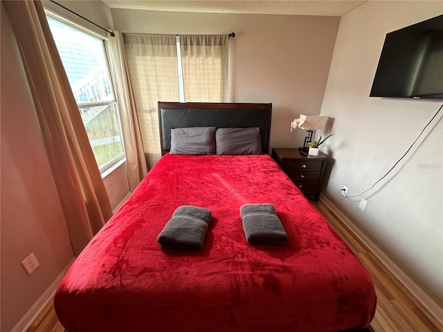 2729 N Poinciana Blvd Unit 117, Kissimmee, FL 34746 - bedroom with wood finished floors, multiple windows, and baseboards