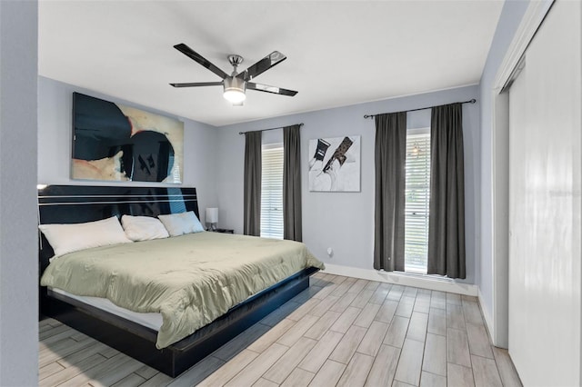 bedroom featuring a closet, light wood-type flooring, and ceiling fan