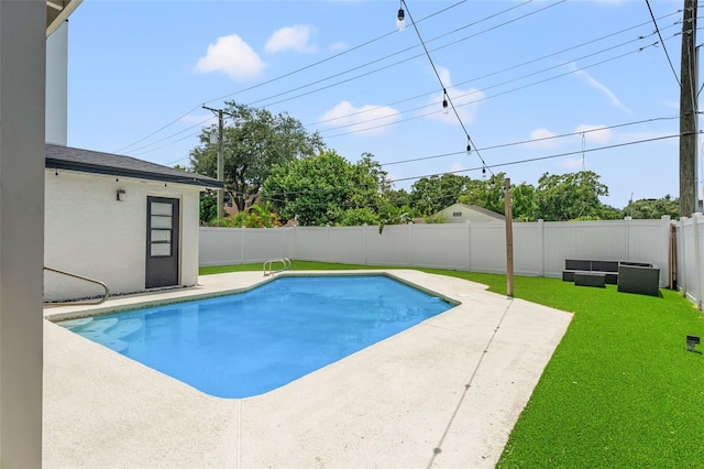 view of pool with a yard and a patio area