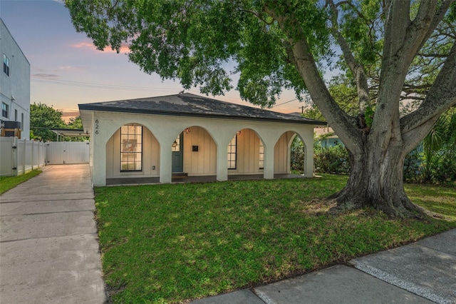 view of front facade with a porch and a lawn