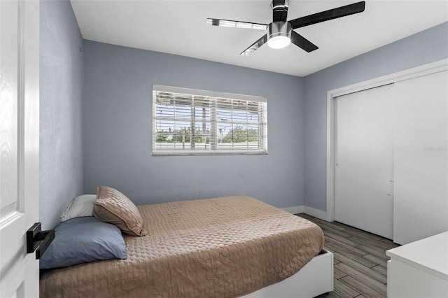 bedroom with ceiling fan, a closet, and light hardwood / wood-style flooring