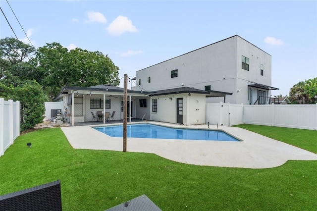 view of swimming pool featuring a yard and a patio area