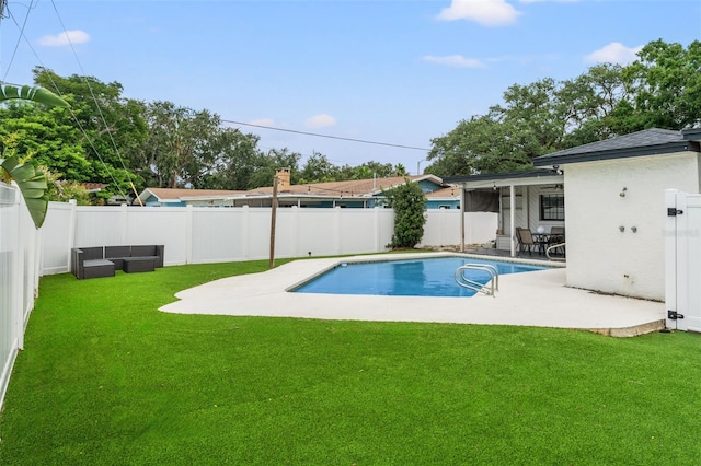 view of swimming pool featuring a lawn and a patio