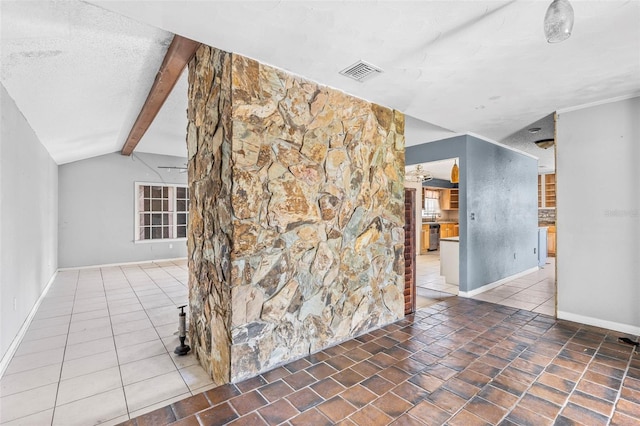 tiled spare room with a textured ceiling and vaulted ceiling with beams