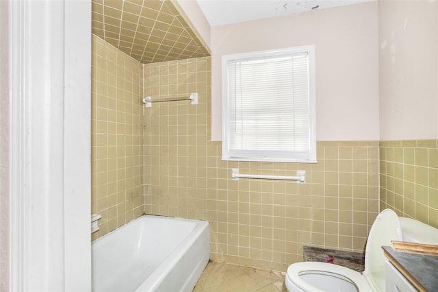 bathroom featuring tile walls, toilet, vanity, and tile patterned floors