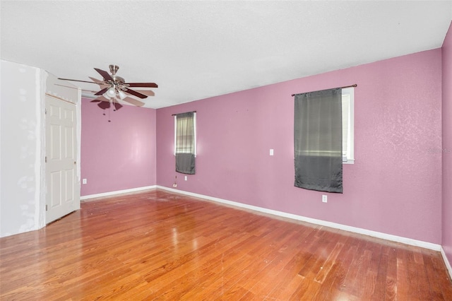 unfurnished room featuring ceiling fan and hardwood / wood-style floors