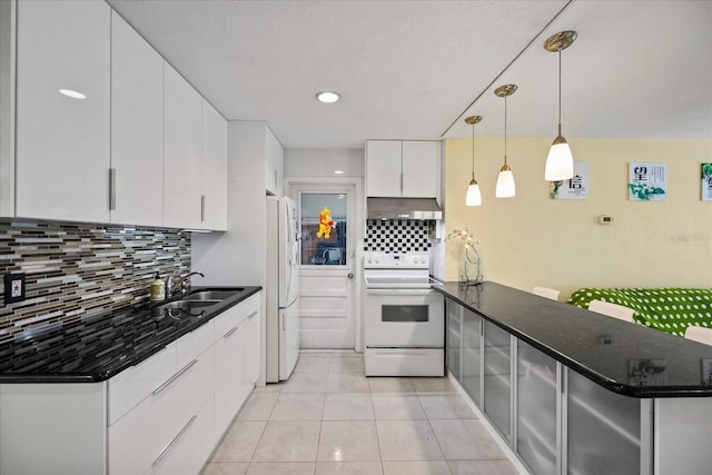 kitchen featuring decorative light fixtures, white cabinetry, backsplash, and white appliances