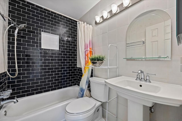 bathroom with tile walls, shower / tub combo with curtain, and toilet