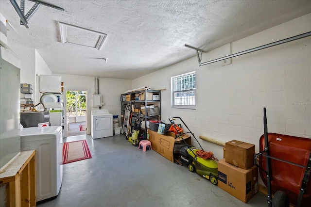 garage featuring washer and dryer and water heater