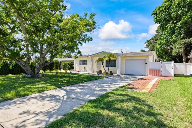 ranch-style home featuring a garage and a front yard