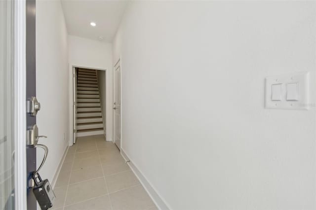 hall with recessed lighting, baseboards, and light tile patterned floors