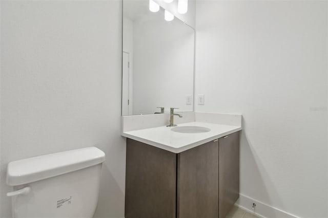 half bathroom with vanity and toilet