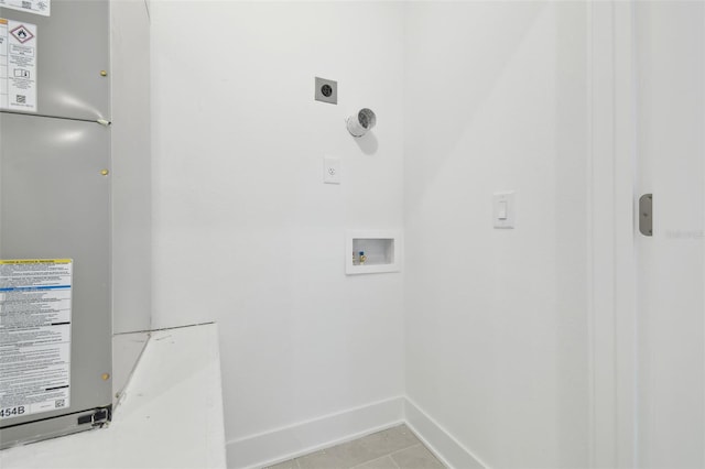 laundry room featuring light tile patterned floors, laundry area, baseboards, hookup for a washing machine, and hookup for an electric dryer