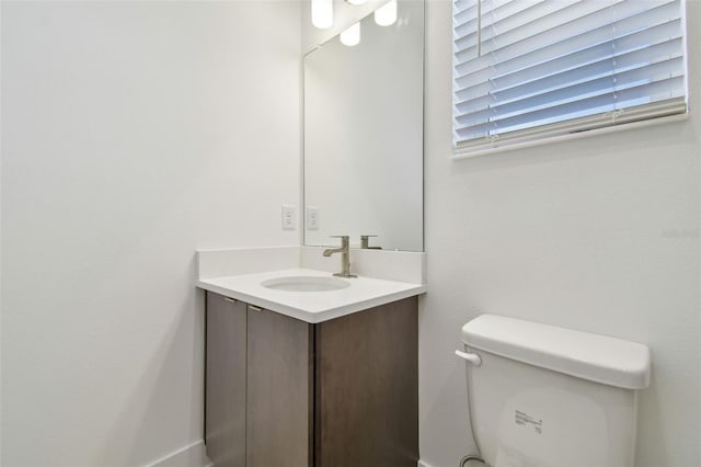 half bathroom featuring toilet and vanity