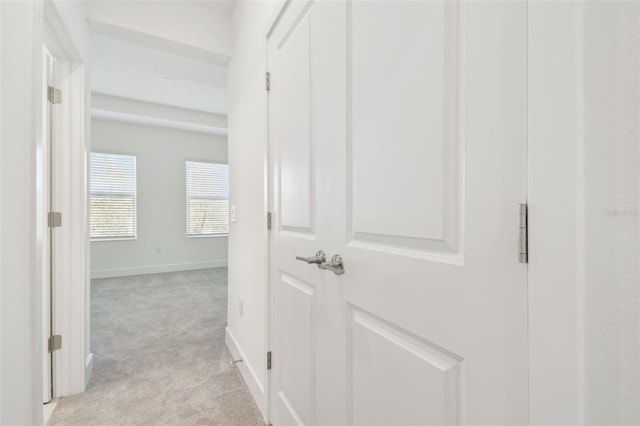 hallway with light carpet and baseboards