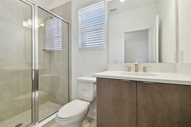 full bath featuring toilet, a stall shower, visible vents, and vanity