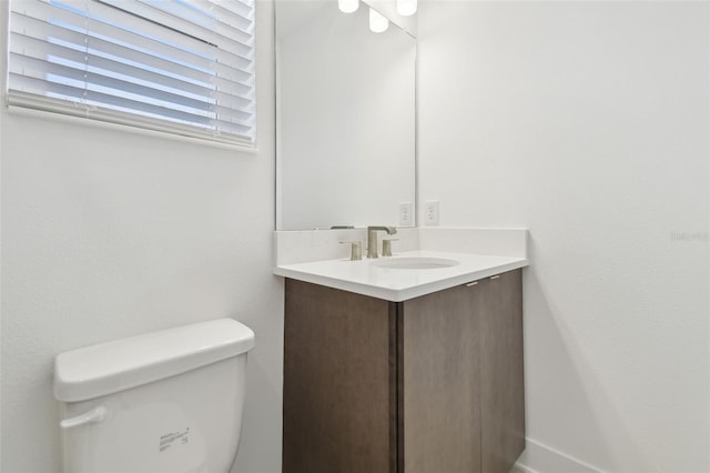 bathroom featuring toilet and vanity