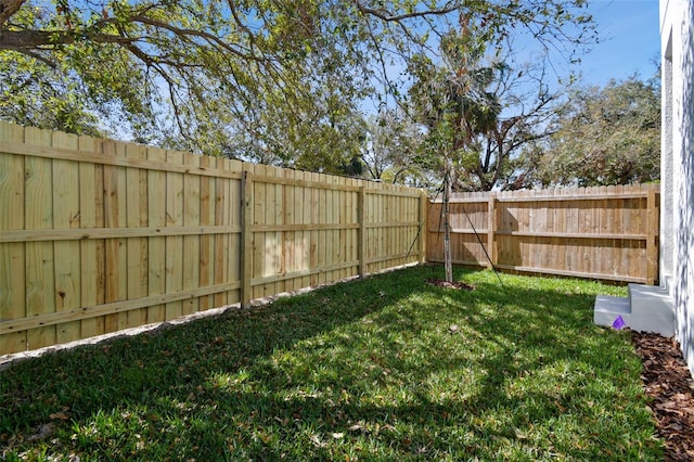 view of yard with a fenced backyard