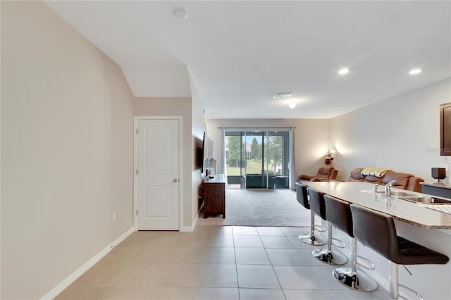 dining area featuring light carpet