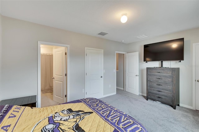 bedroom featuring carpet and ensuite bath