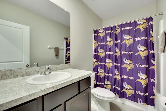 full bathroom with vanity, shower / tub combo with curtain, and toilet