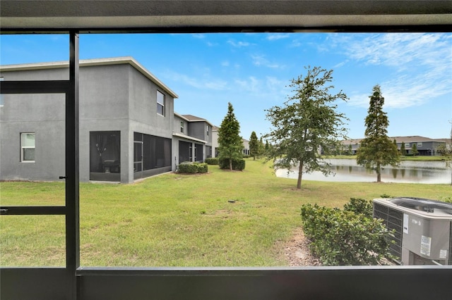 view of yard featuring central air condition unit and a sunroom