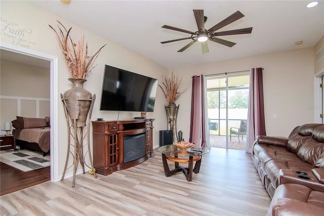 living room with ceiling fan and light wood-type flooring