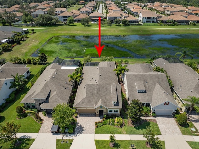 bird's eye view with a water view and a residential view