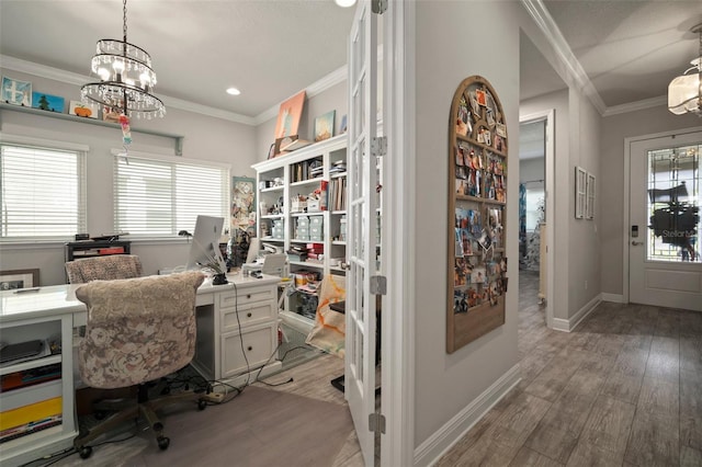 office featuring ornamental molding, light hardwood / wood-style flooring, and a notable chandelier