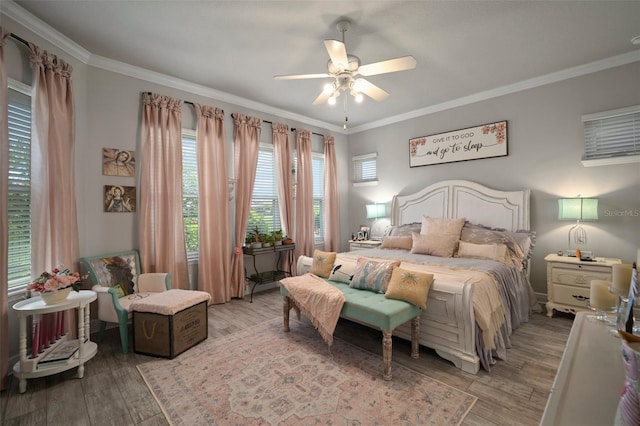 bedroom with ceiling fan, light hardwood / wood-style floors, and ornamental molding