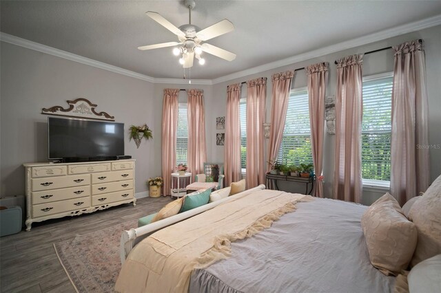 bedroom featuring ornamental molding, ceiling fan, and dark wood-type flooring