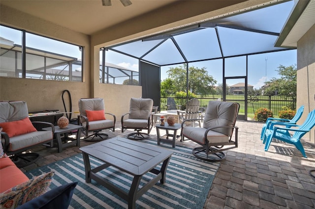 view of patio / terrace with glass enclosure, an outdoor living space, and ceiling fan