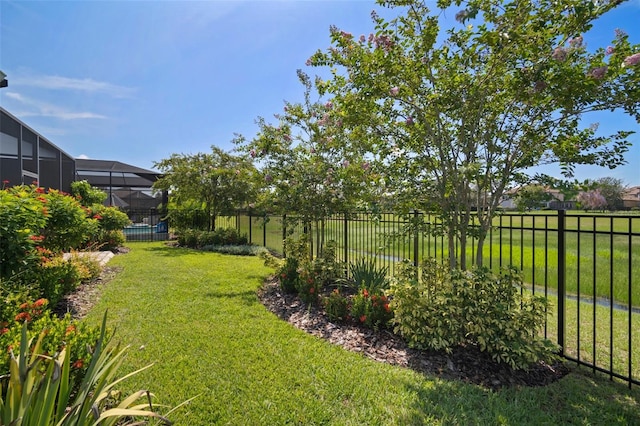 view of yard with glass enclosure