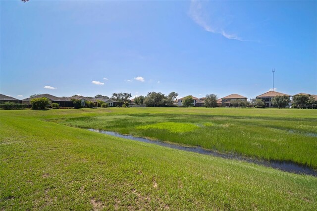 view of community featuring a yard and a water view