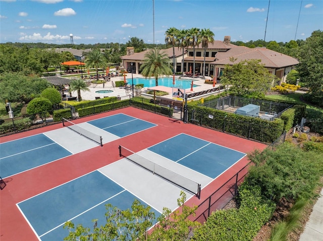 view of tennis court with basketball court and a community pool