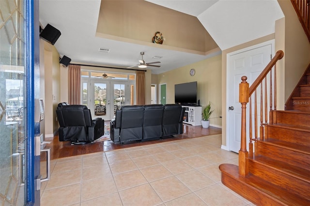 living room featuring ceiling fan, light hardwood / wood-style flooring, and french doors