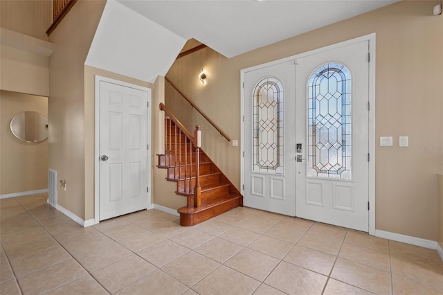 entryway featuring light tile patterned floors and french doors