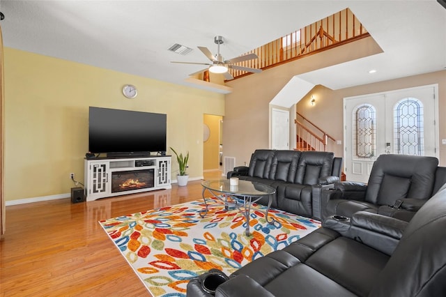 living room with hardwood / wood-style flooring, french doors, and ceiling fan