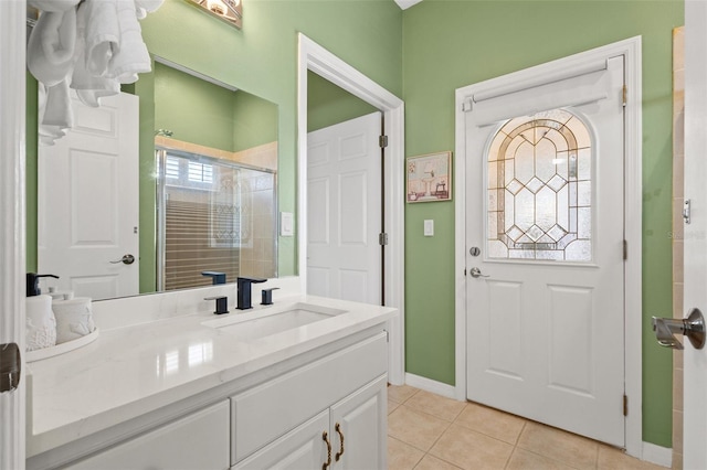 bathroom featuring an enclosed shower, vanity, and tile patterned floors