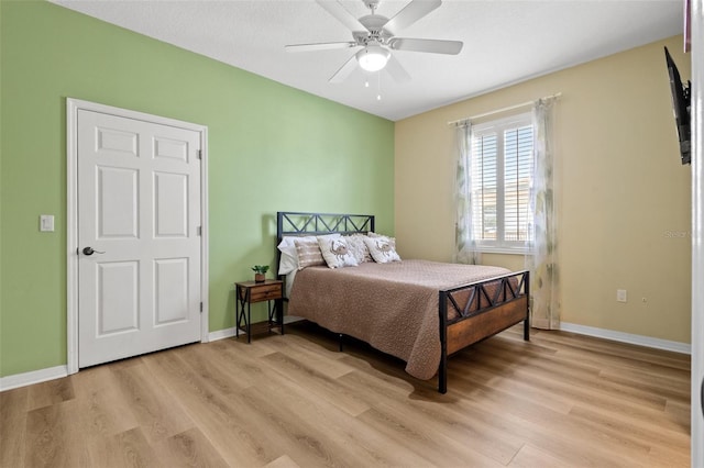 bedroom with ceiling fan and light hardwood / wood-style floors