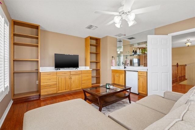 living room featuring ceiling fan and hardwood / wood-style flooring